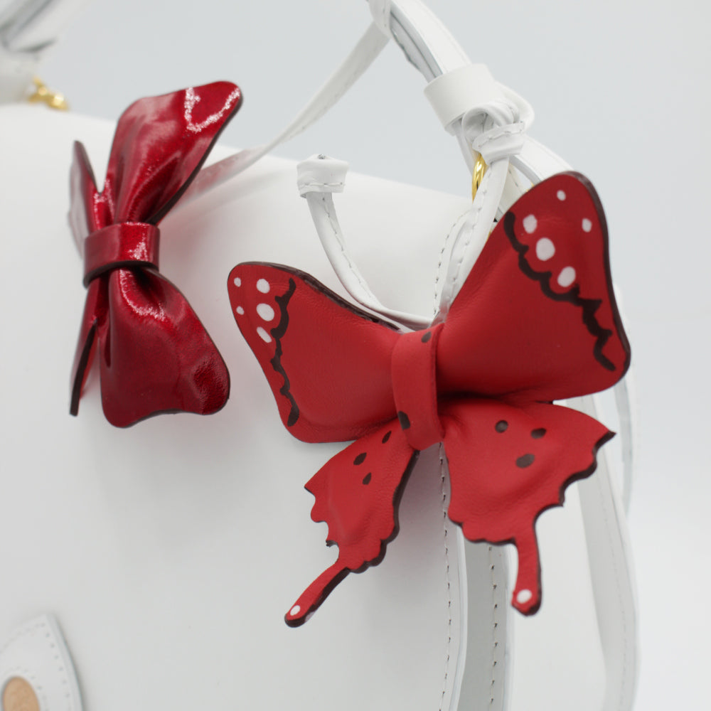 Bijou de sac – Cuir rouge papillons